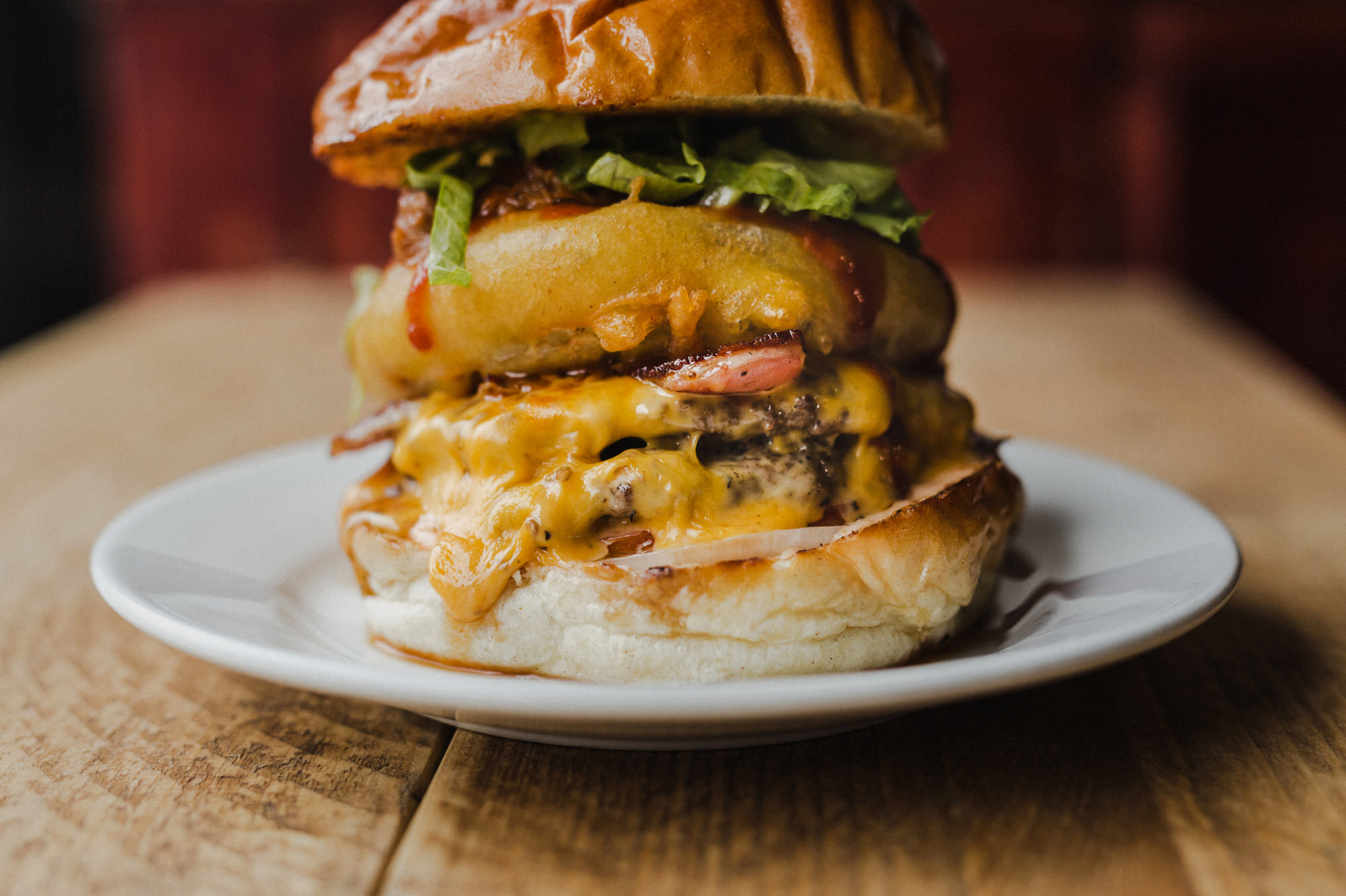 A hero close-up of a stacked beef burger shot in Glasgow, part of a food photography portfolio.