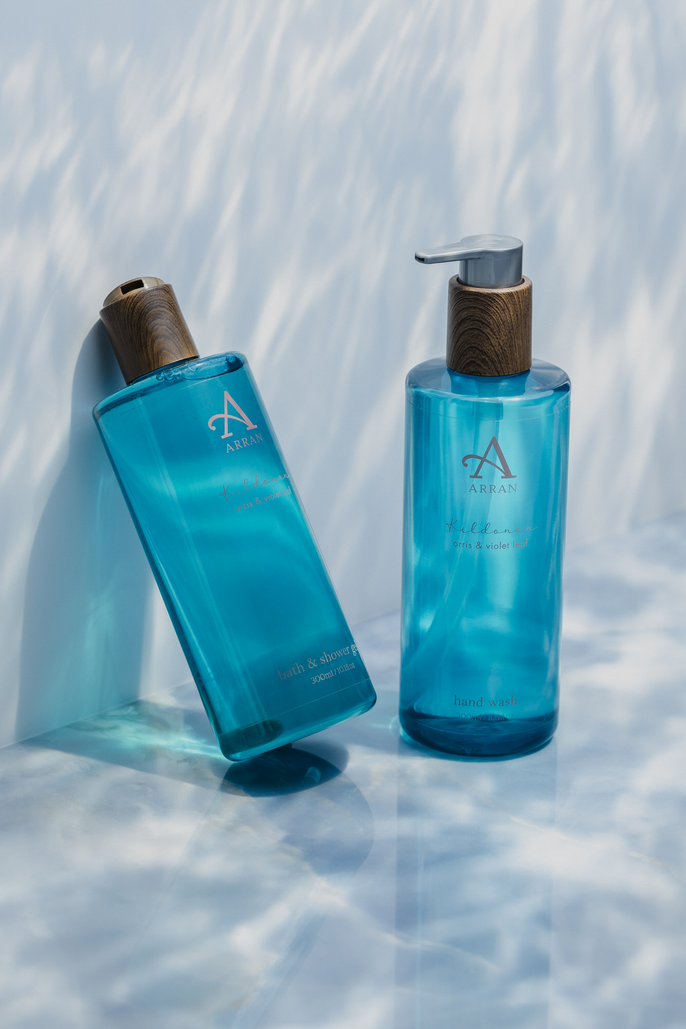 Glasgow product photographer - Arran Aromatics Kildonan shower gel products shot in a studio with an aqua backdrop